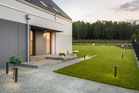New villa with garden and decorative outdoor lighting, external viewの写真素材
