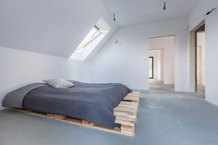 White attic flat with hipster DIY bed and windowの写真素材