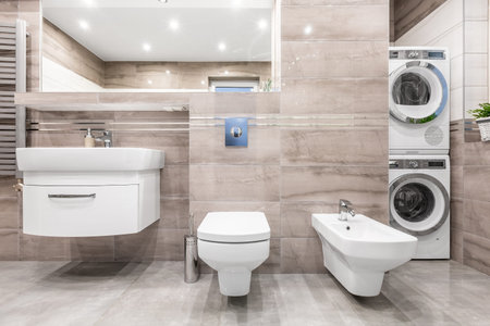 High gloss bathroom with basin cabinet, mirror, toilet, bidet, washer and clothes dryer
