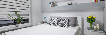 Panorama of light bedroom in new style with window and double bedの写真素材