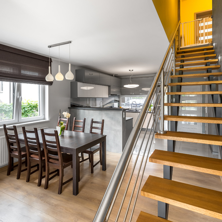 Open floor apartment with stairs, dining area and open kitchenの写真素材