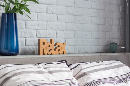 Stylish decorations in new bedroom with double bed and brick wallの写真素材