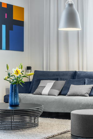Cozy living room with sofa and openwork coffee tableの写真素材