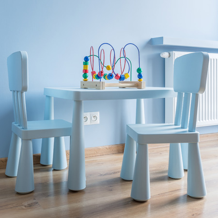 Child's room in blue with small table and two chairsの写真素材