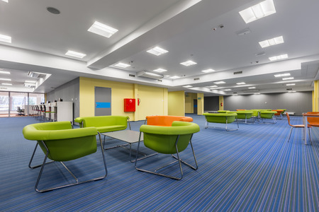 University leisure area with fluo green furniture and modern blue flooringの写真素材
