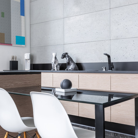 Kitchen with island, table chairs, long worktop and grey tilesの写真素材