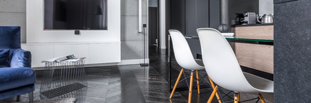 Stylish living room with in grey open to kitchen, panoramaの写真素材