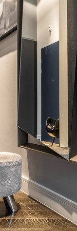 Vertical panorama of home corridor with big mirror and small stoolの写真素材