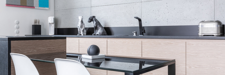 Kicthen with island, table, chairs, long worktop and grey tiles, panoramaの写真素材