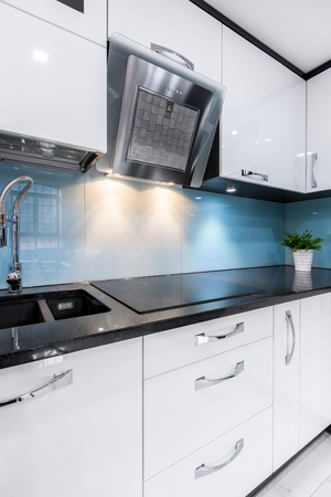 Luxury kitchen with modern white furniture and kitchenwareの写真素材
