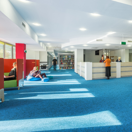 Modern and spacious university library with reception and blue carpetの写真素材