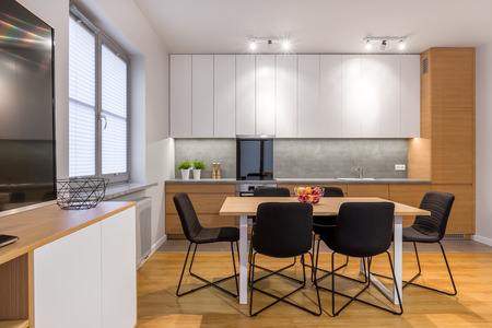 Dining table and chairs in modern, bright and open kitchenの写真素材