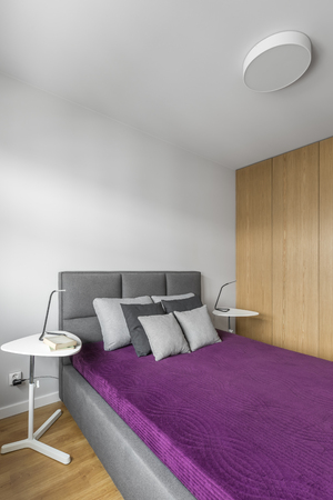Spacious, comfortable double bed in modern master bedroomの写真素材