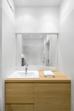 Luxury bathroom interior with big wooden commode and mirrorの写真素材