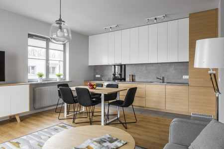 Contemporary kitchen with modern furniture and big table with black chairsの写真素材