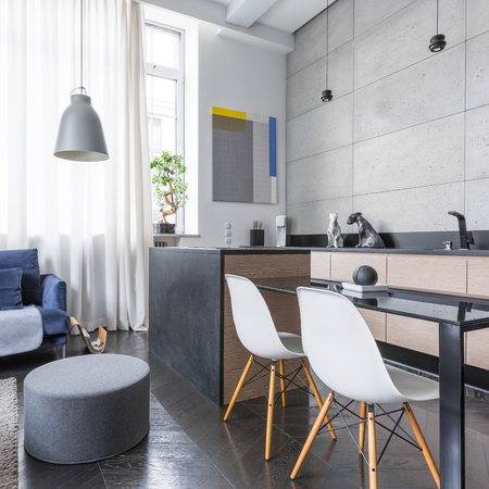 Modern studio apartment with kitchenette and living roomの写真素材