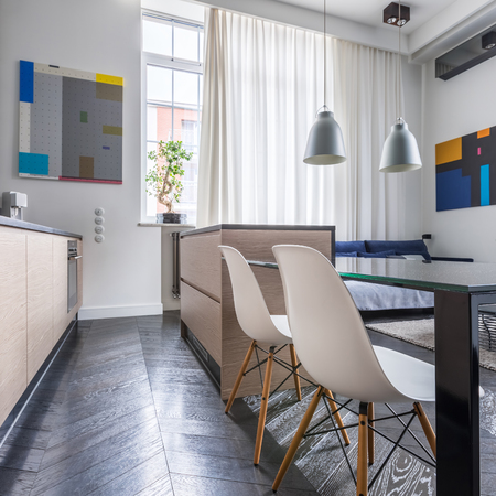 Open kitchen with island, table and two white chairsの写真素材