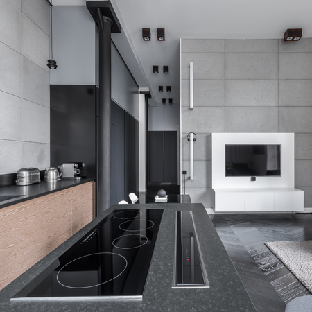Open and modern cooking area in stylish and multifunctional apartmentの写真素材