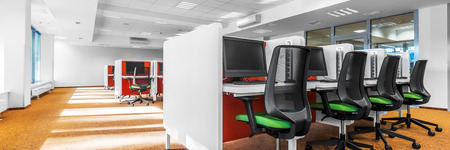 Panorama of stylish computer classroom with modern orange carpet on the floorの写真素材