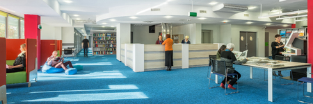 Panorama of modern and spacious university library with blue carpet on the floorの写真素材