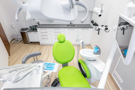 Modern dental office with green chair and professional computer anesthesia systemの写真素材