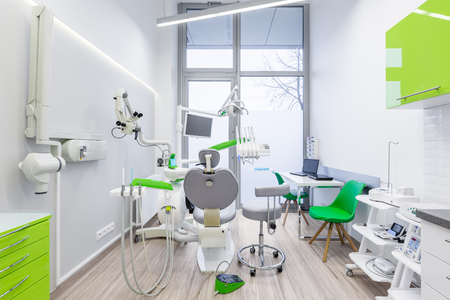 White, dental office interior with green furniture and modern toolsの写真素材