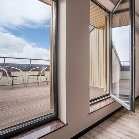 Luxurious home interior with big windows and exit to the modern balconyの写真素材