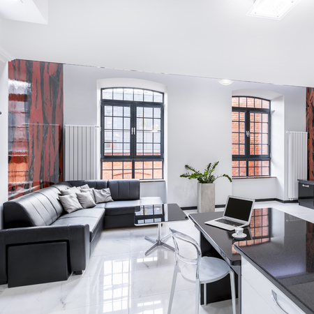 Modern designed apartment with open living room, desk and computerの写真素材