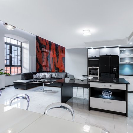 Modern, white apartment with kitchen open to living roomの写真素材