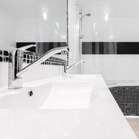Fancy bathroom interior with two white classical washbasins and two faucetsの写真素材