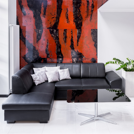 Luxury living room with large sofa, lamp, black and red marble wallの写真素材