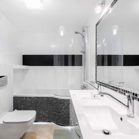 Elegant bathroom interior with modern black mosaic accents and big mirrorの写真素材