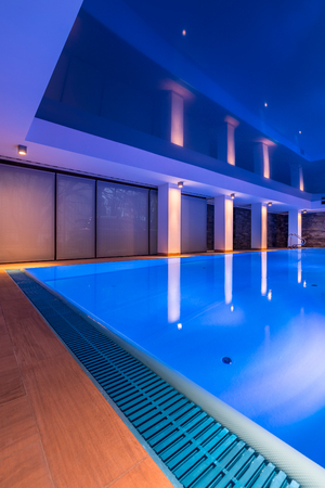 Modern indoor swimming pool with cozy warm lightningの写真素材