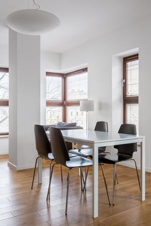 Bright dining room with big windows in modern apartmentの写真素材