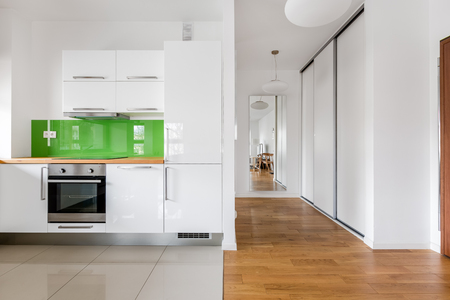 Open space with small modern kitchen in new flatの写真素材