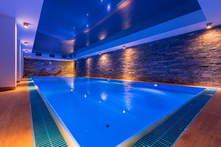 Luxury indoor swimming pool in modern hotel spaの写真素材
