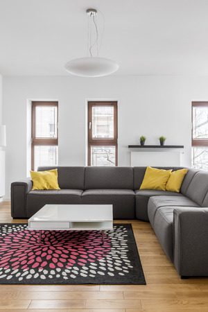 Comfortable corner couch in modern apartment living roomの写真素材