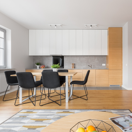 Luxury open space kitchen with big table and black chairsの写真素材