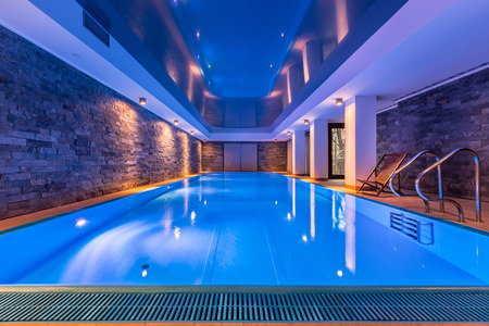 Luxurious villa swimming pool with brick walls, evening viewの写真素材