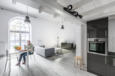 Modern open plan apartment with kitchen, living room and dining areaの写真素材