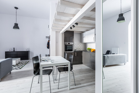 Kitchen with wooden ceiling and white dining tableの写真素材