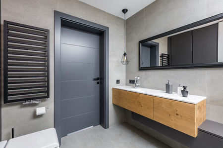 Dark and elegant bathroom with countertop basin and mirrorの写真素材