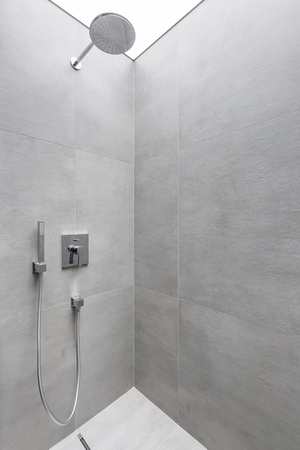Modern walk in shower with gray wall tilesの写真素材