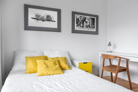 White bedroom with double bed, desk and wooden chair