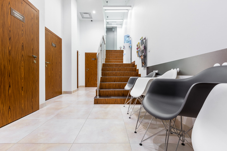Clinic interior with black and white chairs and stairsの写真素材