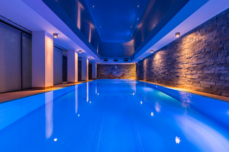 Swimming pool with decorative led lights and brick wallの写真素材