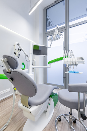 Dentist chair and advanced equipment in modern dental clinicの写真素材