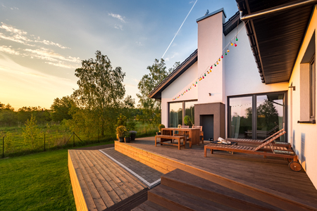 Modern house with patio and functional outdoor furnitureの写真素材