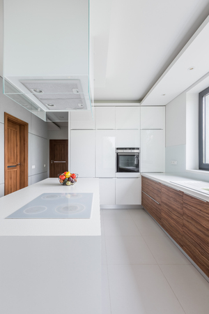 Beautiful, white kitchen with island, countertop and wooden cupboardsの写真素材