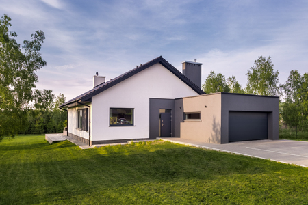 Cozy family house with garden and garage, outdoorsの写真素材
